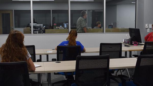 a group of people sitting at desks